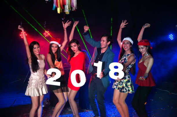 group of people dancing at night club with santa hat christmas holidays party. - political party concepts glamour friendship imagens e fotografias de stock