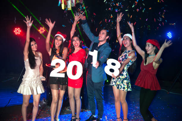 group of people dancing at night club with santa hat christmas holidays party. - political party concepts glamour friendship imagens e fotografias de stock