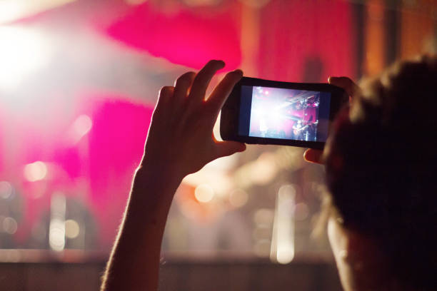 istock Fan Photographing Through Smart Phone While Enjoying Music Concert 865166676