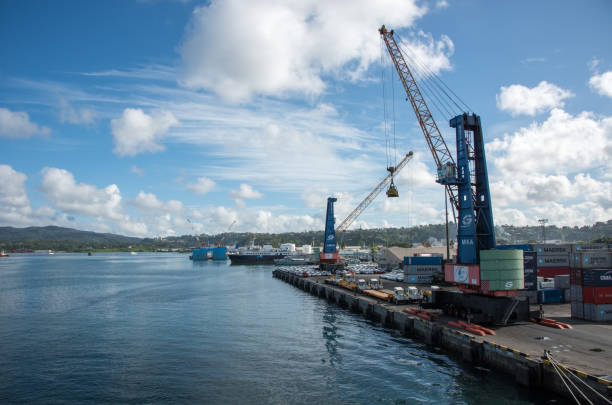 Dock in Fiji Suva, Viti Levu, Fiji-November 28, 2016: Commercial dock with cranes, cargo containers, vehicles and boats in the Pacific Ocean in Suva, Fiji suva photos stock pictures, royalty-free photos & images