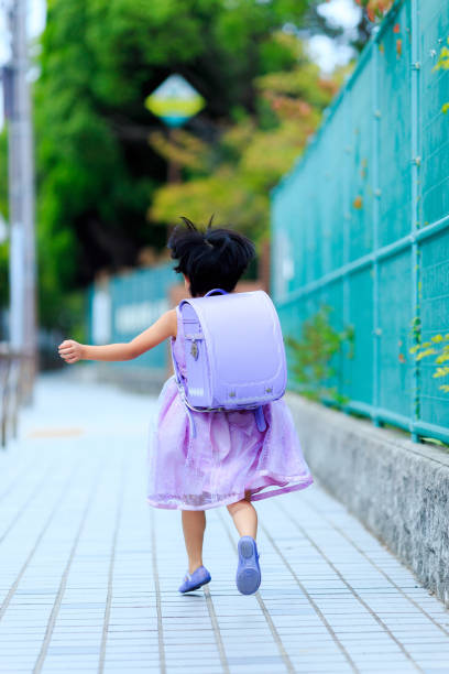 istock Girls carrying a school bag 865167638