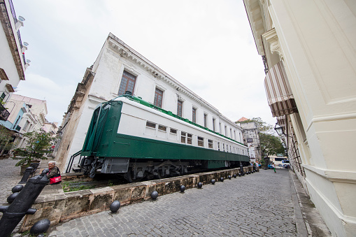 The photo focuses on Coche Mambi a 1900 train car built in the US and brought to Cuba in 1912. Put into service as the Presidential Car, it’s a palace on wheels, with a formal dining room inside.Wide angle view.