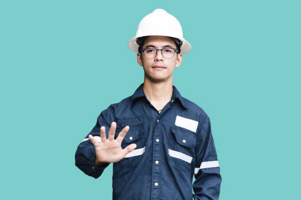 istock Asian man,Engineer or Technician in white helmet, glasses and blue working shirt suit pointing finger, isolated on white, mechanic and Oil and Gas industrial concept with clipping path. 865223828