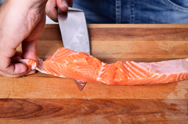 istock Cutting the salmon with a knife 865226404