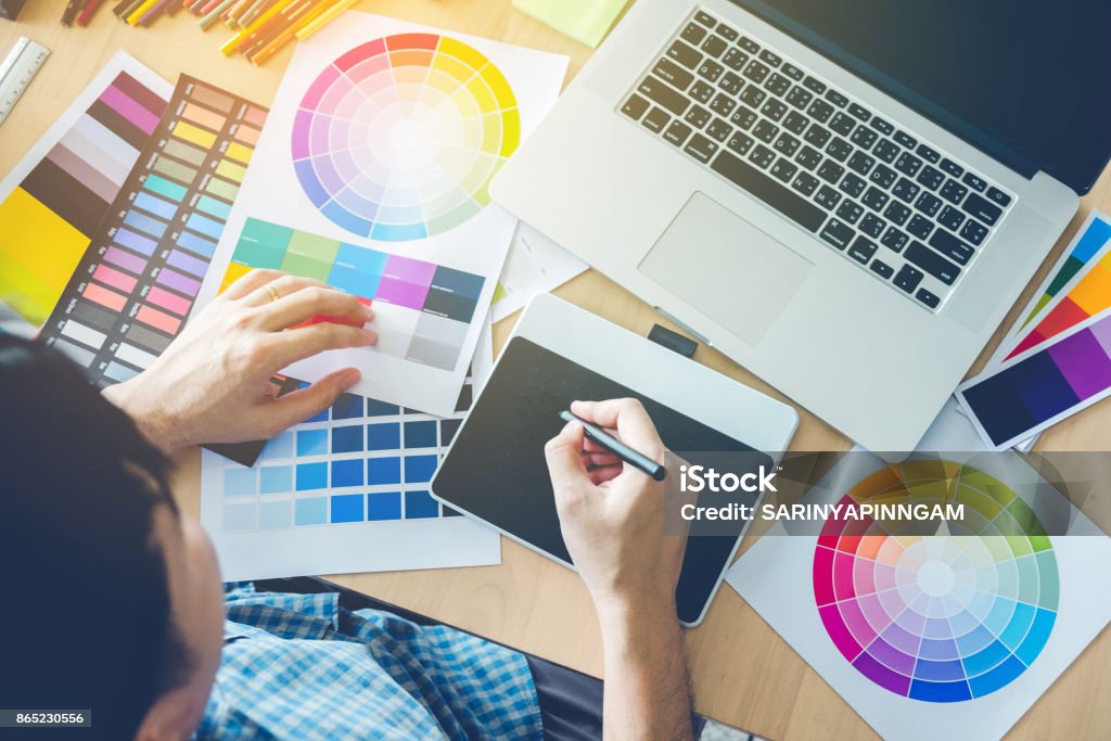 Graphic designer drawing on graphics tablet at workplace Graphic Designer Stock Photo
