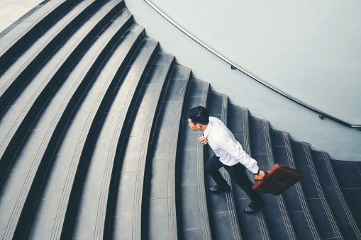 Businessman running fast upstairs Growth up Success concept