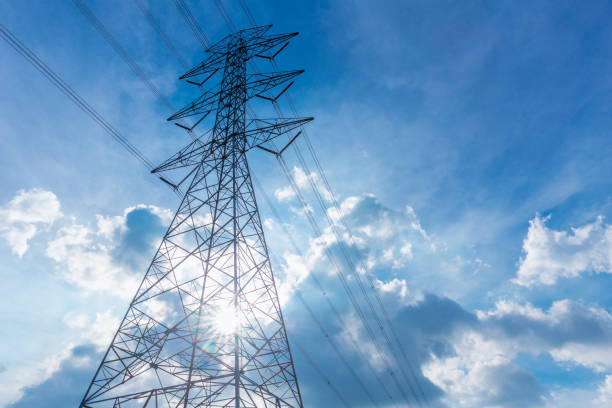 istock high voltage electricity power line silhouette with blue cloud sky background 865237494