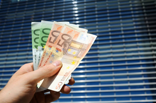 istock Euro money in front of office building 865237814