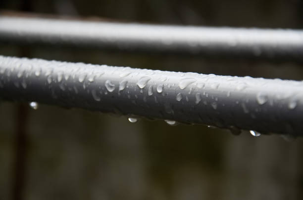 Drop of water on the steel pipe (Selective focus)