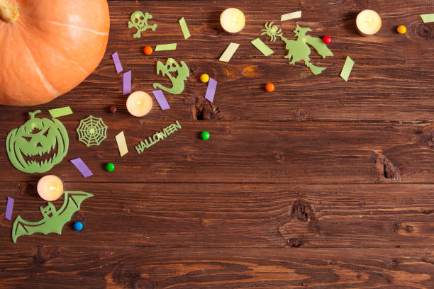 istock Halloween holiday background with pumpkin and candy. View from above 865245026