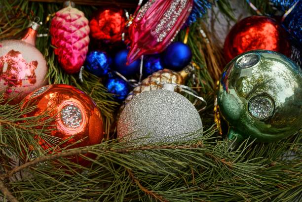 istock beautiful Christmas toys and balls in green coniferous branches 865249154