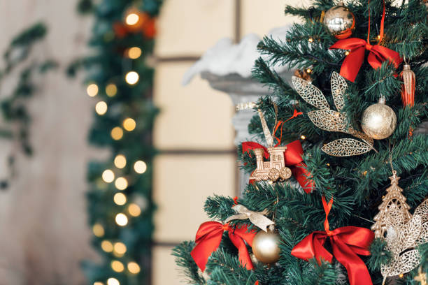 istock Christmas toy train and garland on the fir tree 865249596