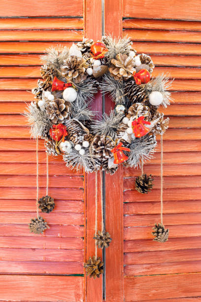 istock Christmas wreath hanging on wooden blinds 865251910