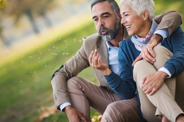 istock Mid aged couple in a park 865254278