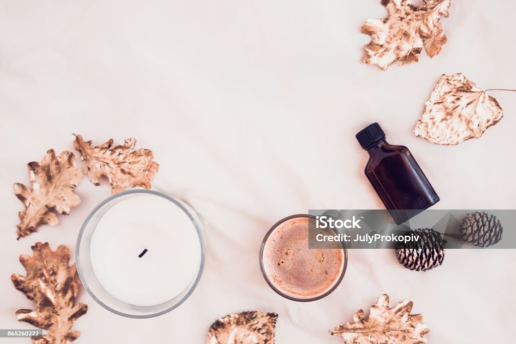 Fall spa beauty products flatlay on white Fall spa beauty products from above on white bed sheets. Copy space for text Candle Stock Photo