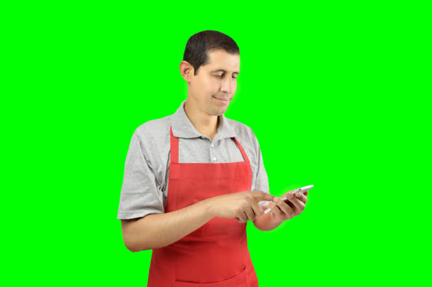 shopman uses a smart phone isolated cutout on green background with chroma key