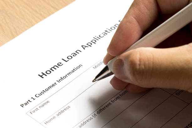 istock Man wait to fill information in home loan application form on desk background 865260954