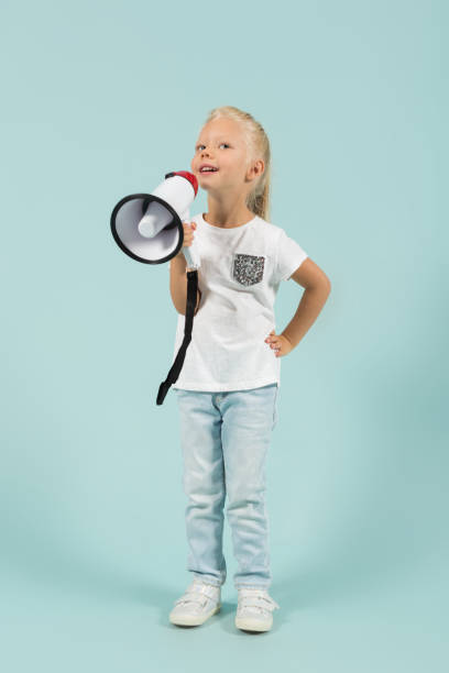 istock Attractive cute girl in light clothes hold megaphone 865264502