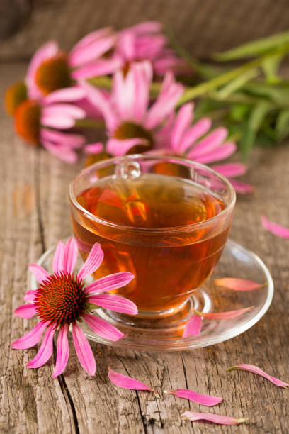 istock Cup of echinacea tea on old wooden table 865271890