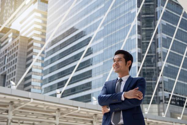 istock Confident businessman with arm crossed aiming higher target 865272306