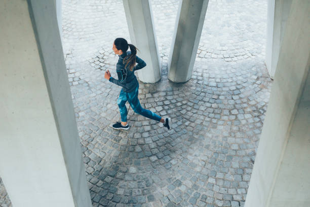 istock Woman jogging outdoors 865272764
