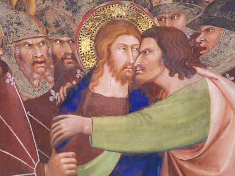 Judas betrays Jesus with a kiss. 14th Century Fresco in the Collegiata of San Gimignano, Italy.