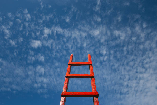 istock Red Staircase Rests Against Blue Sky. Development motivation Career Growth Concept 865287658