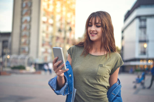 istock Young female  student texting  in the  city 865287690