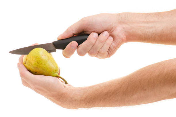 istock Male hands cut of pear with a knife 865288418