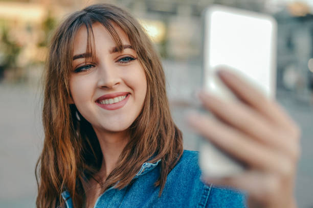 istock Young female  student taking selfie in the city 865292692