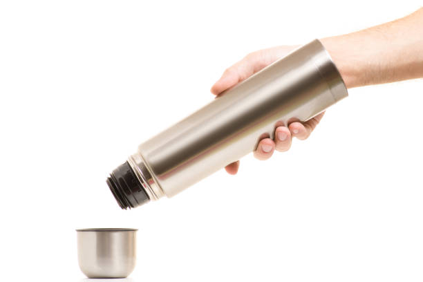 istock Thermos with a cup in male  hands 865292770
