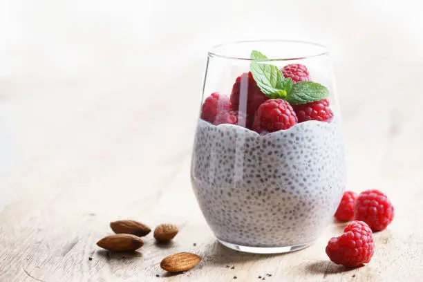 chia seed pudding almond milk with fresh raspberries, healthy eating.