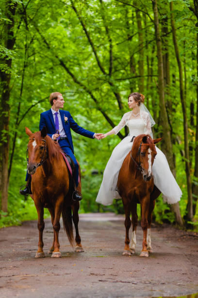 istock Beautiful newlyweds riding two horses 865298692