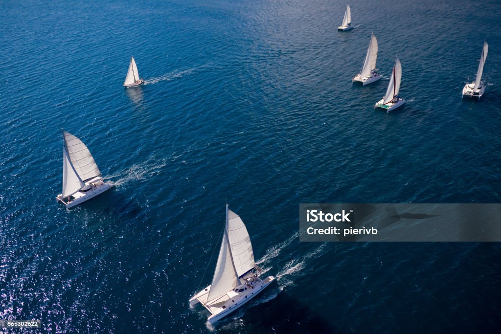 Regatta in the Indian Ocean Regatta in the Indian Ocean, monohulls and catamarans Sailboat Stock Photo