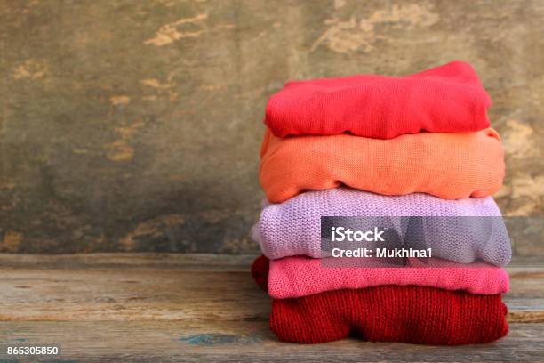 Pile Of Colorful Warm Clothes On Wooden Background Toned Image Stock Photo - Download Image Now