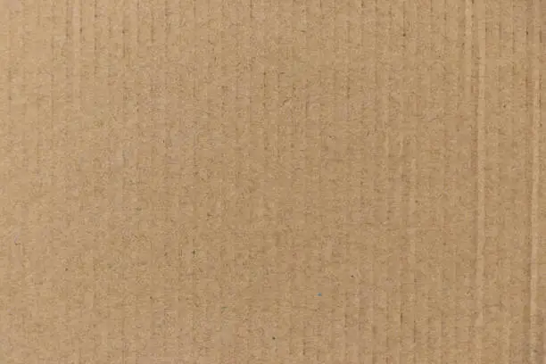 Photo of Closed up of brown color corrugated paper board background used as wallpaper, decoration, design element