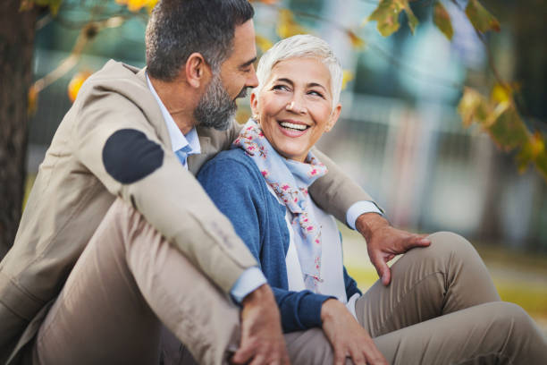 istock Mid aged couple in a park 865306562