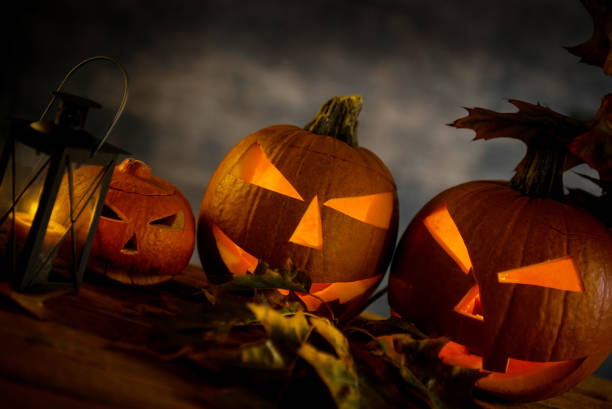 istock Halloween design with pumpkins. golden bokeh 865309062