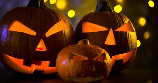 istock Halloween design with pumpkins. golden bokeh 865309380