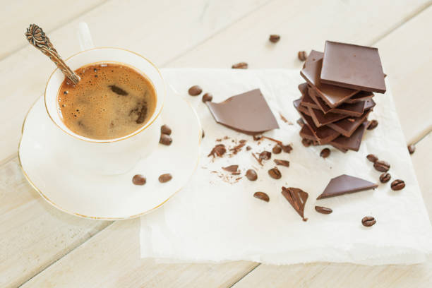 istock Chocolate with a cup of coffee and loose coffee beans 865310648