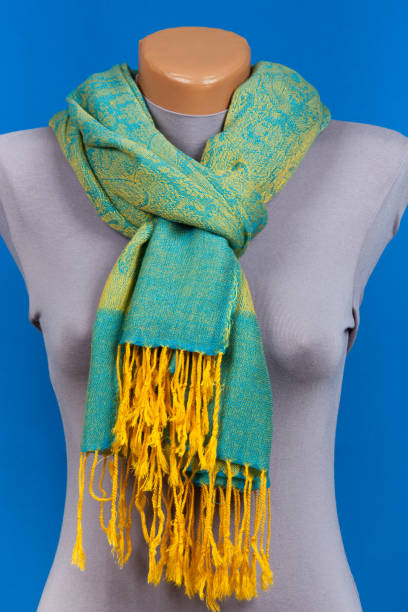 istock Green scarf on mannequin isolated on blue background. 865314088