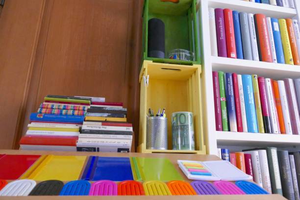 istock Organizing the Ibrary: full shelves with a table and working equipment on it 865316440