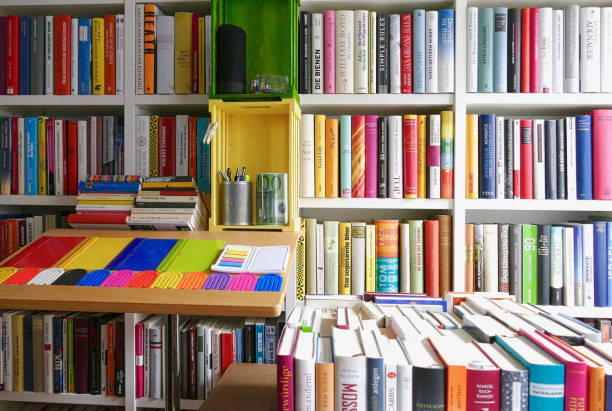 istock Organizing the Ibrary: full shelves with a table and working equipment on it 865316508
