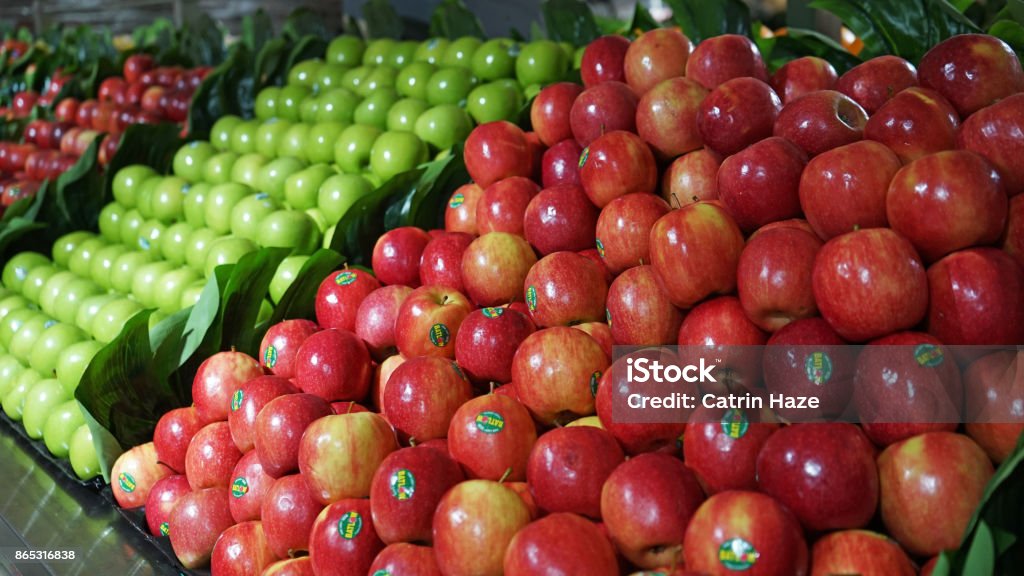 Fruit aisle with piles of red and green apples in supermarket Fruit aisle with piles of red and green apples in the supermarket Apple - Fruit Stock Photo