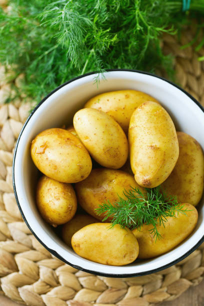 istock raw baby potatoes on wooden surface 865320262