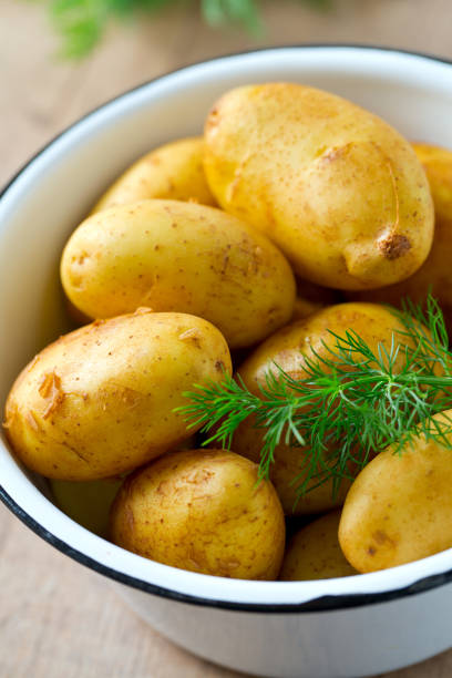 istock raw baby potatoes on wooden surface 865320268