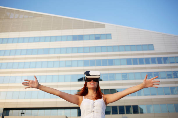 istock Happy woman using virtual reality headset in urban environment 865320568