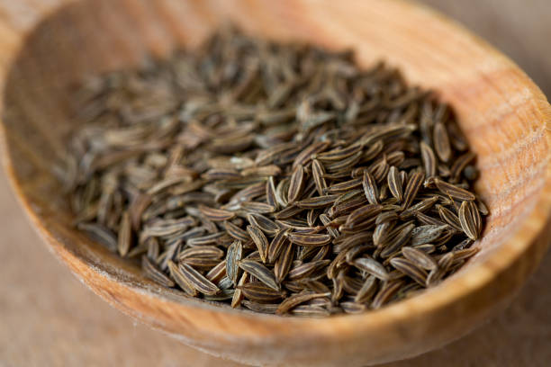 istock dried cumin on wooden surface 865323460