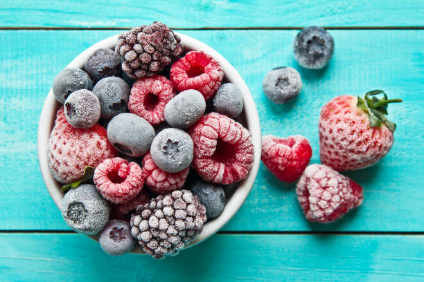 Frozen berries in a bowl. Various mix berry stock photo