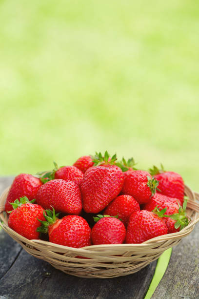 istock Basket with strawberries on a garden wooden table 865327656